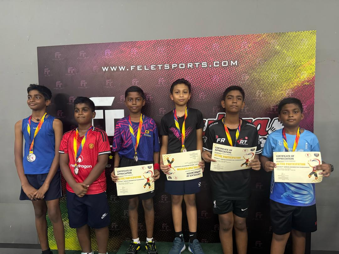 Students with medals at the badminton tournament