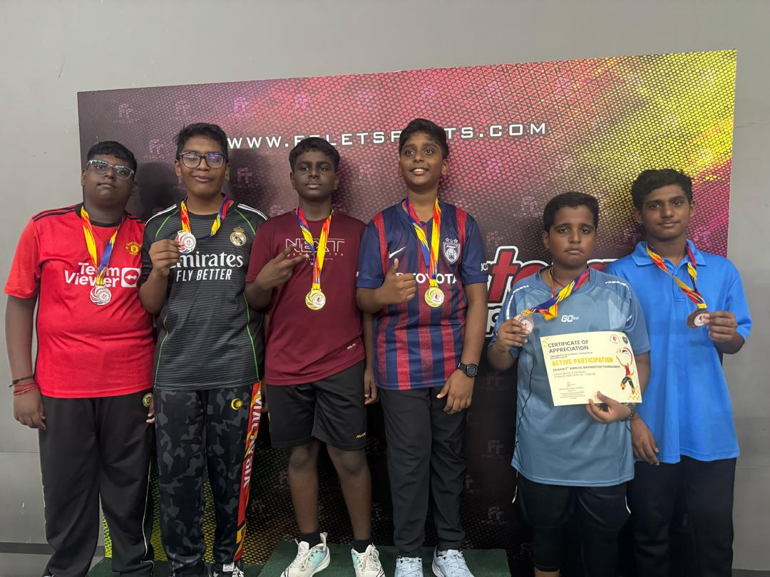 Students with medals at the badminton tournament