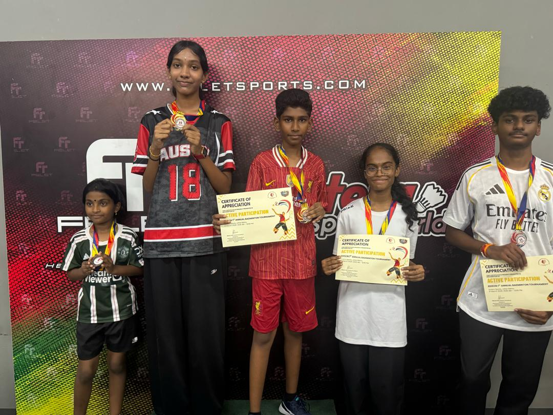 Students with medals at the badminton tournament